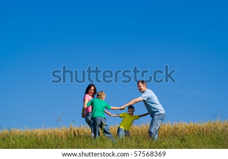 cheerful family dancing round
