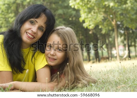 Mother and daughter walking in a summer park