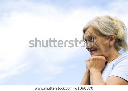 beautiful older woman stands on the sky