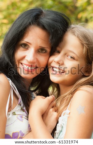 Mother and daughter walking in a park
