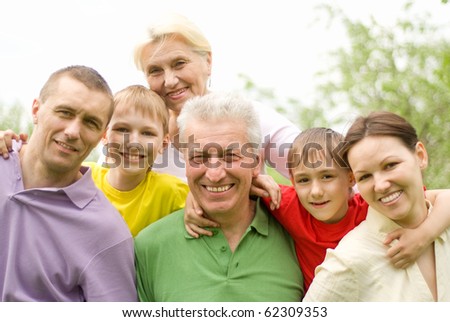 large family plays in the summer park