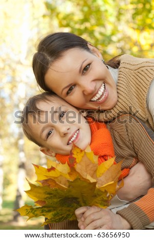 stock photo Mom and son walking in a park