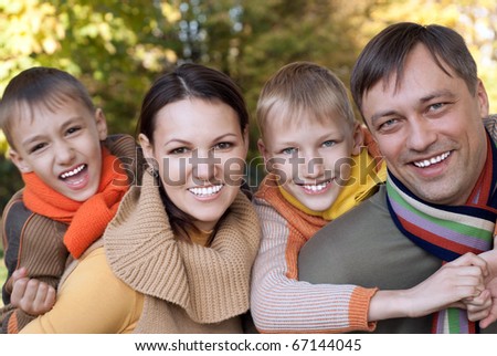 happy nice family of four on the nature