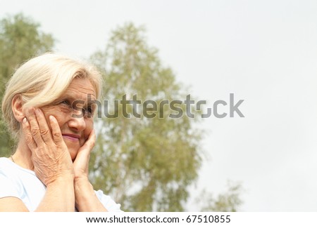 beautiful older woman stands on the sky