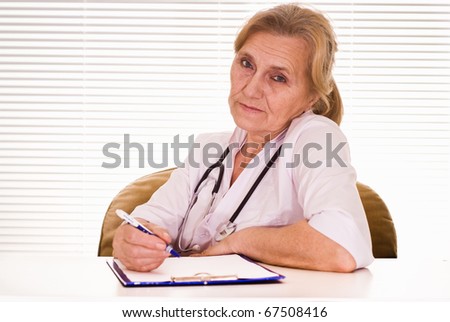 nice elderly woman doctor on a white background