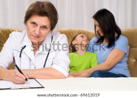 doctor and mom with a boy on a white