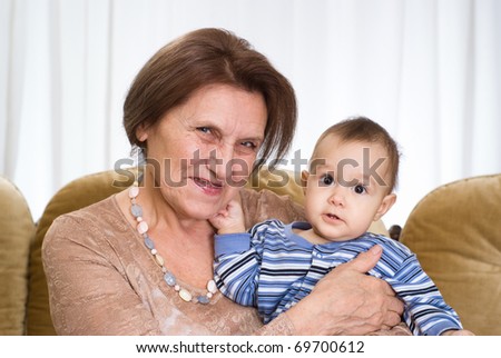 elderly woman holding a newborn on a white