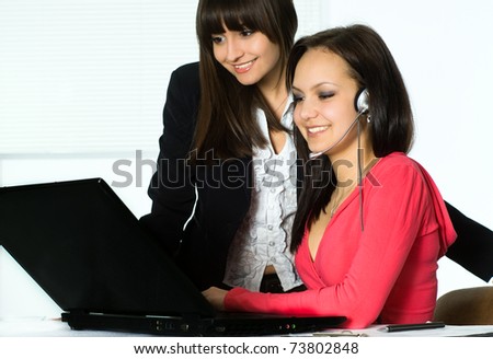 Two beautiful girls working in the office