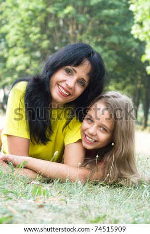 Mother and daughter walking in a park