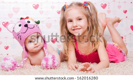 Two sisters with different mood (happy and unhappy)