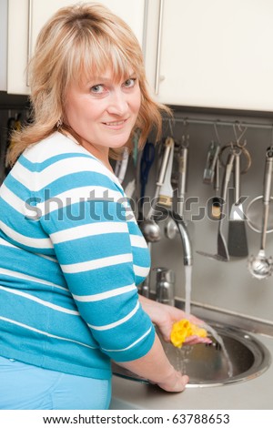 beautiful woman washes dishes