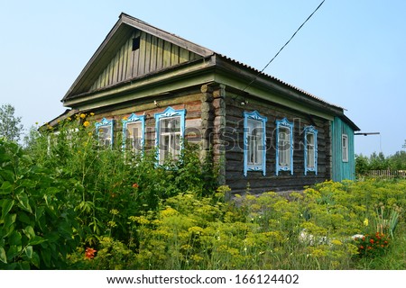 The wooden house in the village in the summer.