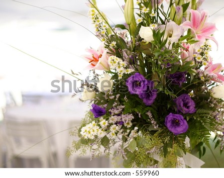 stock photo Floral arrangement at outdoor tent wedding