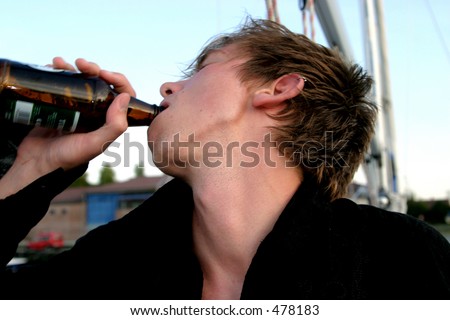 Boy drinking beer outside
