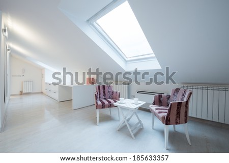 Interior of a bright white cozy loft in luxury apartment - place for relaxing