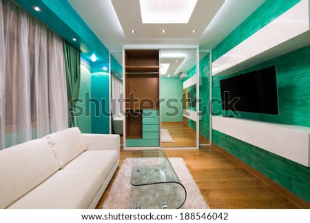 Interior of a modern green living room with luxury ceiling lights