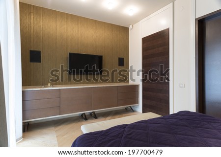 Bedroom interior with wall mounted tv and speakers