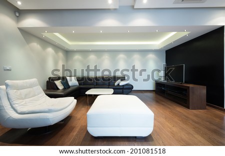 Interior of a spacious luxury living room with colorful ceiling lights