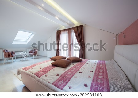 Interior of a bright white cozy bedroom in luxury loft apartment