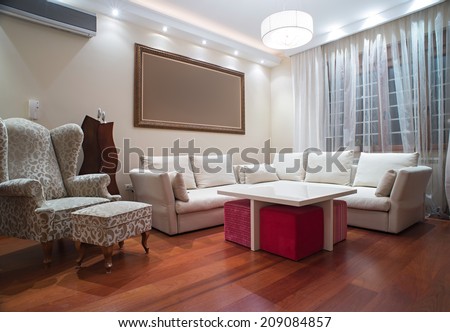 Luxury living room with modern ceiling lights - evening shot