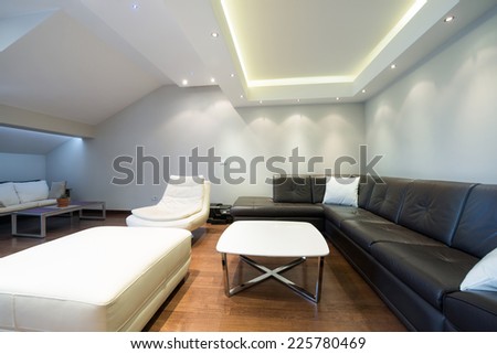 Interior of a spacious luxury living room with ceiling lights