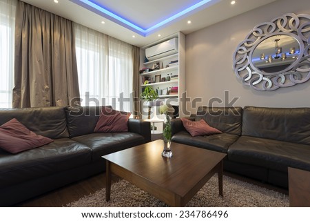Modern living room interior with blue ceiling lights