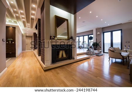 Luxury apartment interior with fireplace filed with candles