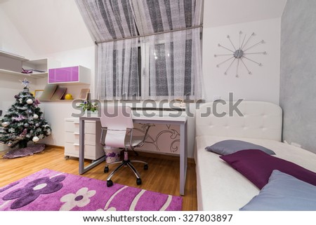 Interior of a teenage girl room with decorated Christmas tree