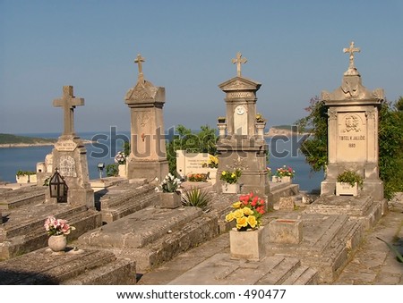 Marble tombs overlooking a cliff in Croatia (note to reviewer...the letters in the names were moved around to protect the dead)