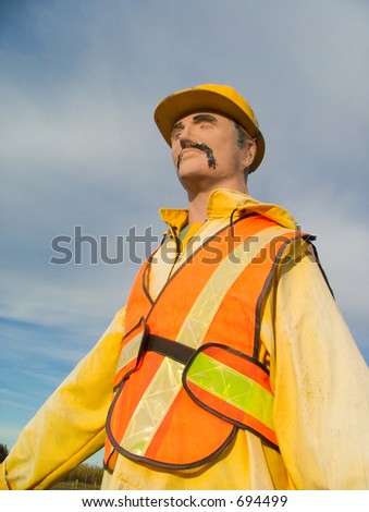Mannequin wearing a yellow and orange safety gear