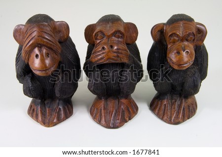 Three African statuettes of wise monkeys that see no evil, speak no evil and hear no evil.