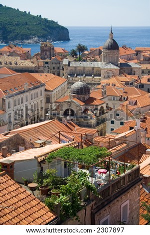 A view of the roofs of Dubrovnik with an emphasis on a rooftop garden, the cathedral and the St-Blaise church