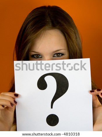 A teenager peeking above a white sheet with a question mark. May be used to illustrate 