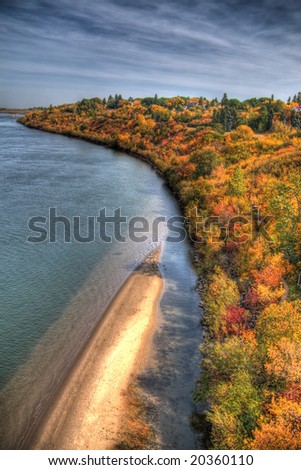 East shore of the South Saskatchewan River across from downtown Saskatoon. HDR image created by combining 3 different exposures. Minor chromatic aberrations are inevitable in this type of processing.