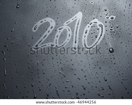 water drops on a dark grey, glossy background with text: 2010