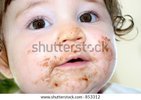 Baby Girl\'s face covered with yummie chocolate!