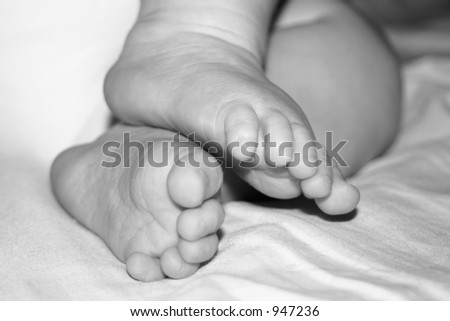 Cute little baby feet, baby sleeping on the side.