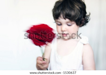 Special effect, little girl waving a rose. Soft focus image.
