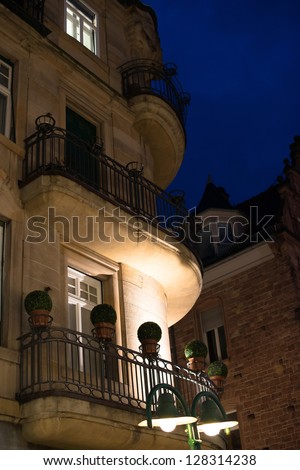 Facade of a beautiful building with balconies and plastic flowers in the evening in Heidelberg, Germany