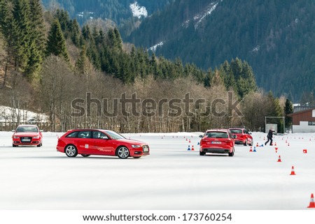 SAALBACH, AUSTRIA - JANUARY 19, 2014: The Audi Driving Experience is training clients how to drive professionally (drift and safety) in winter conditions on January 19, 2014 in Saalbach, Austria.