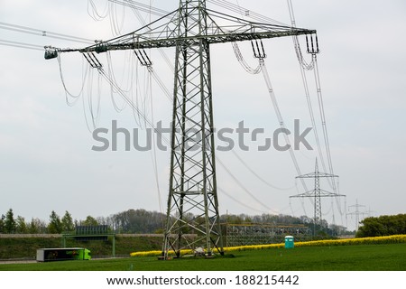 GUENZBURG, GERMANY - April 19, 2014: Construction works on high voltage power pole on April 19,2014 near Guenzburg,Germany.Since the power lines cross the Autobahn,complex safety measures are in place