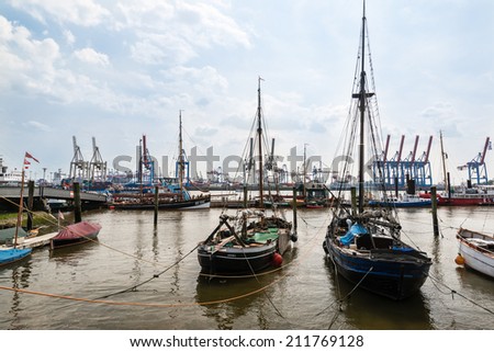 HAMBURG, GERMANY - JULY 21, 2014: The famous Hamburg  museum harbor offers a fantastic view on  historic sailing ships in front of modern container terminals on July 21, 2014 in Hamburg, Germany.