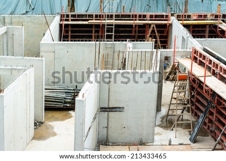 New walls being erected on a construction site with steel enforcements and scaffolding