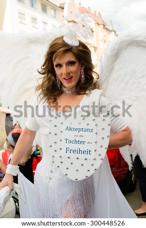 STUTTGART, GERMANY - JULY 25, 2015: A handsome man dressed as woman is presenting the motto of the Christopher Street Day 2015 in Stuttgart: Acceptance is the daughter of Liberty.