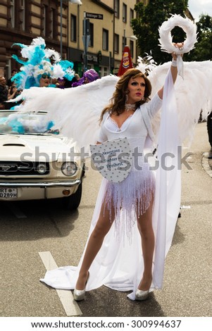 STUTTGART, GERMANY - JULY 25, 2015: A handsome man dressed as woman is presenting the motto of the Christopher Street Day 2015 in Stuttgart: Acceptance is the daughter of Liberty. The Christopher