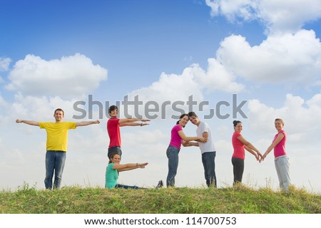 Group of people spelling word TEAM outdoors in nature