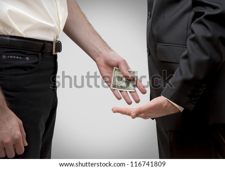 Man secretly giving money to other man