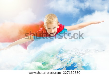 Small superhero boy flying over the Earth. Elements of this image furnished by NASA