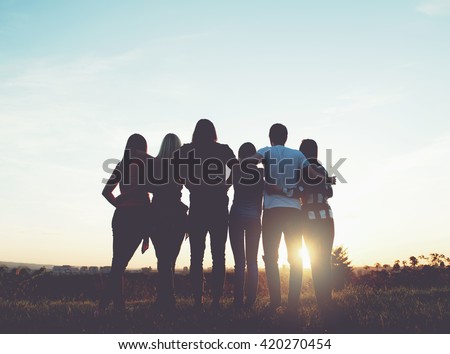 Group of people having fun outdoors; sunset