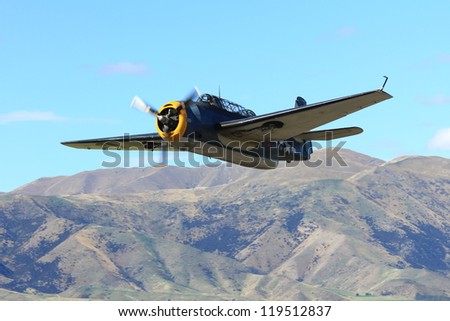 WANAKA-MARCH 03: Grumman avenger aircraft flies over the mountains during the royal New Zealand air force 75th anniversary\
